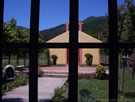 Image of a fence of a church yard with the church behind bars.