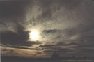 An image of a grave in the Atacama desert with dark clouds in the sky, Chile.